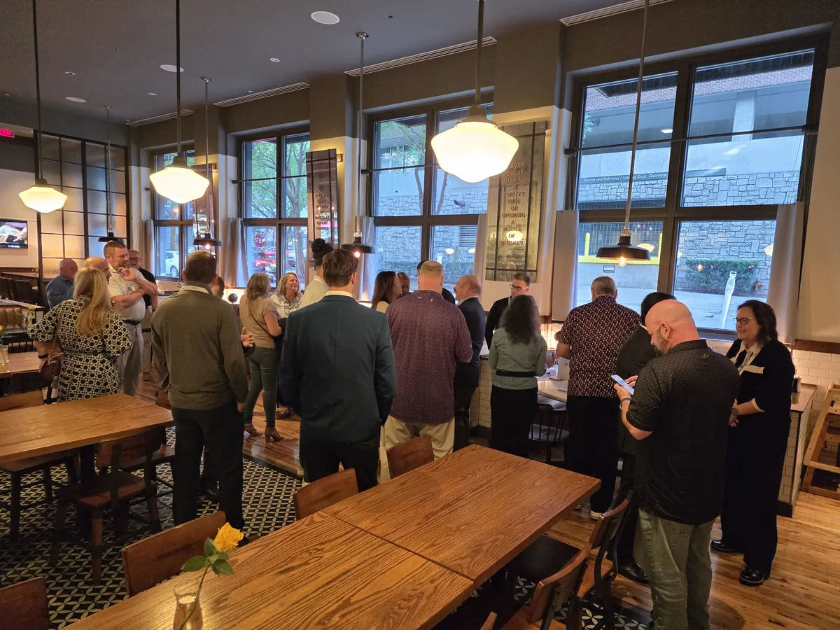 Attendees talking at the RCMA 2026 Fall Meeting welcome reception in Atlanta.